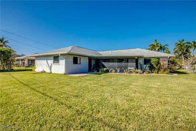 back of property featuring a yard