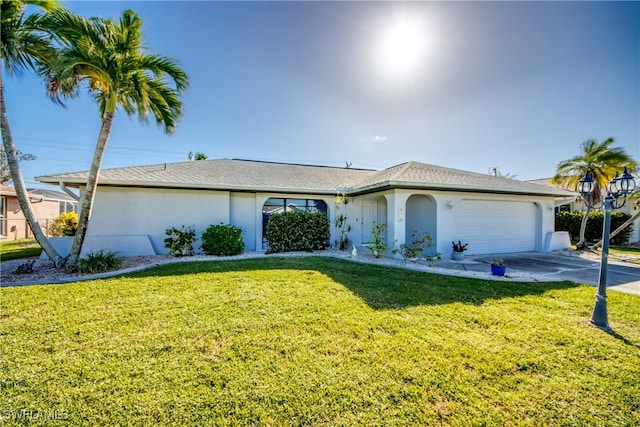 single story home with a front lawn and a garage