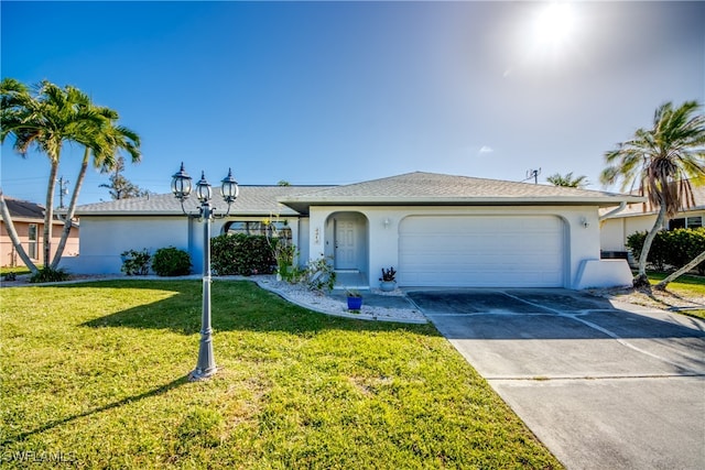 ranch-style house with a garage and a front lawn