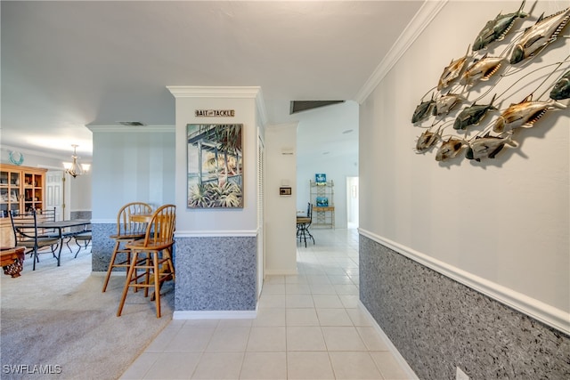 corridor featuring an inviting chandelier, ornamental molding, and light tile patterned floors