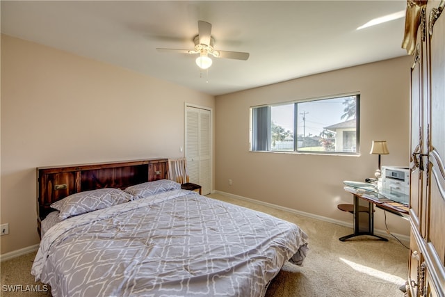 bedroom featuring light carpet, a closet, and ceiling fan