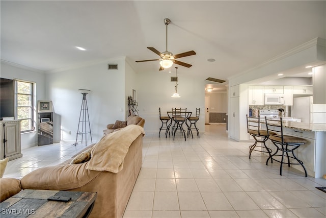 tiled living room with ceiling fan, ornamental molding, and lofted ceiling