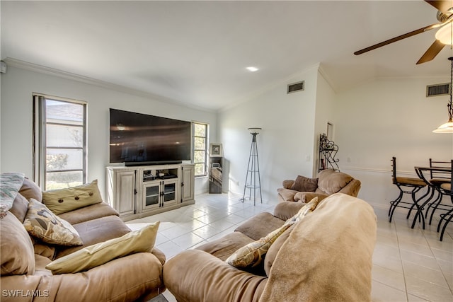 living room with lofted ceiling, crown molding, ceiling fan, and light tile patterned floors