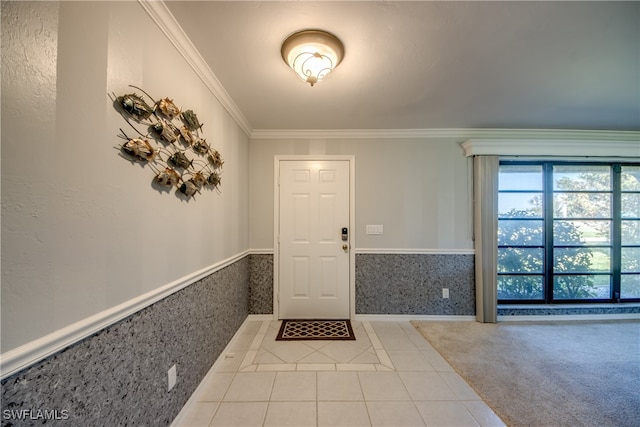 entrance foyer with ornamental molding and light tile patterned floors