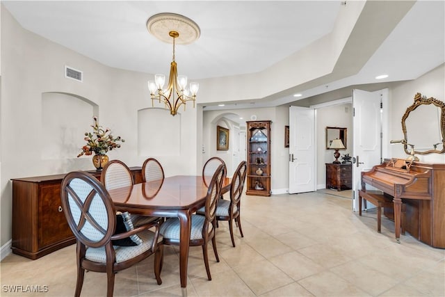 tiled dining area featuring an inviting chandelier