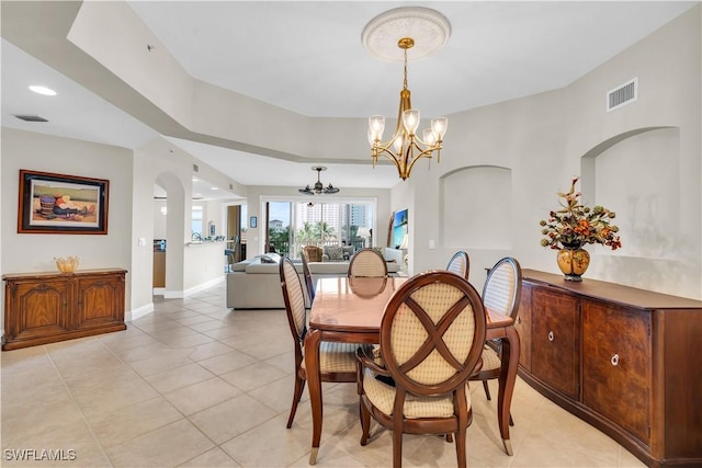 dining space featuring light tile patterned floors and a notable chandelier