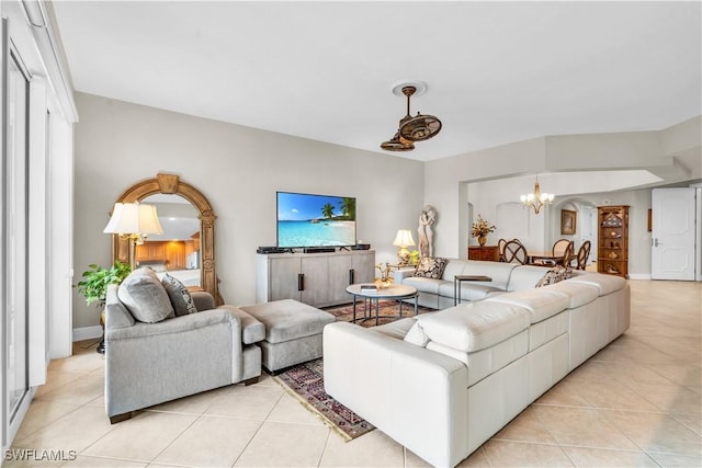 tiled living room featuring an inviting chandelier