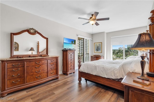 bedroom with ceiling fan, hardwood / wood-style flooring, and multiple windows