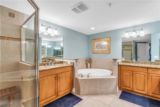 bathroom with tile patterned flooring, shower with separate bathtub, and vanity