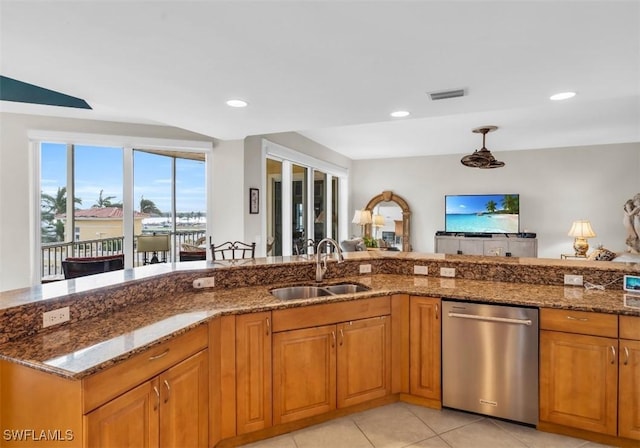 kitchen featuring light tile patterned floors, sink, stainless steel dishwasher, and dark stone countertops