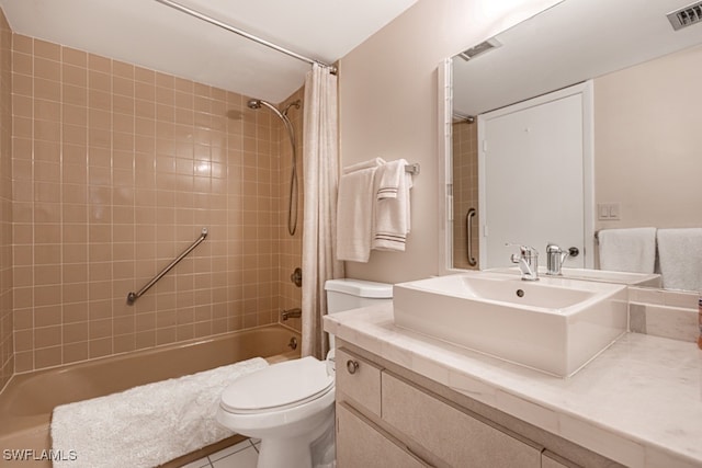 full bathroom featuring vanity, shower / bath combo with shower curtain, toilet, and tile patterned floors