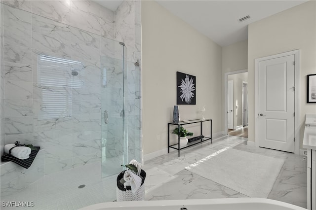 bathroom featuring marble finish floor, vanity, baseboards, visible vents, and a marble finish shower