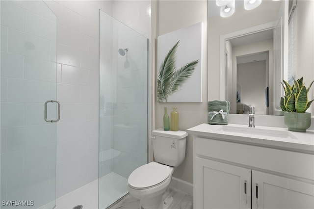 full bathroom with baseboards, toilet, a tile shower, and vanity