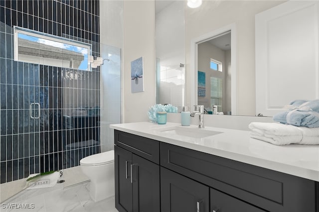 full bathroom with toilet, a wealth of natural light, vanity, and tiled shower