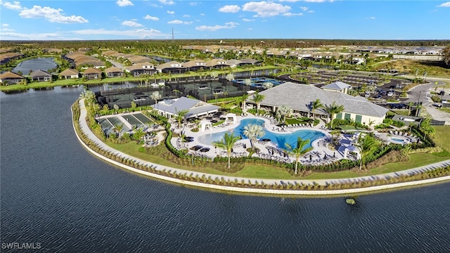 drone / aerial view featuring a water view and a residential view