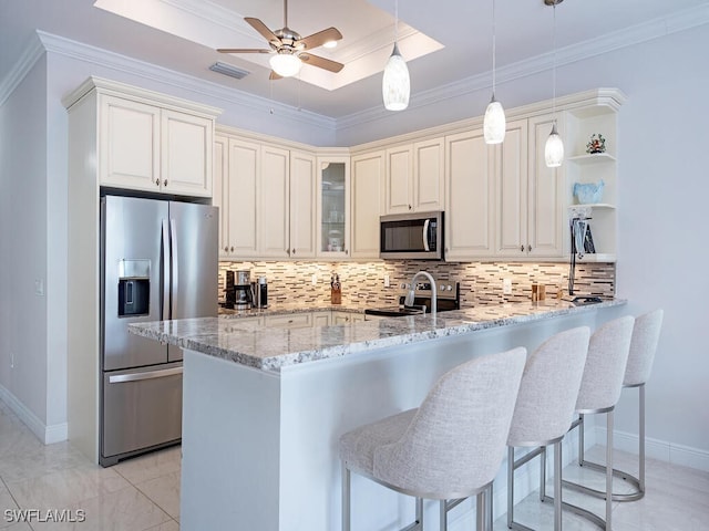 kitchen featuring light stone counters, crown molding, kitchen peninsula, and stainless steel appliances