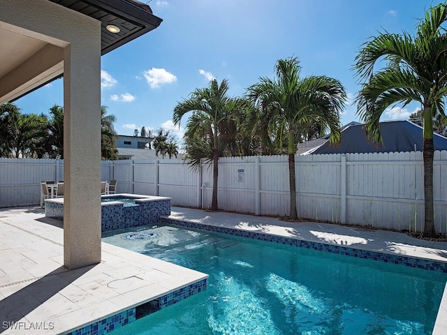 view of swimming pool with a patio and an in ground hot tub