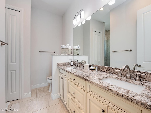 bathroom with vanity, toilet, walk in shower, and tile patterned flooring