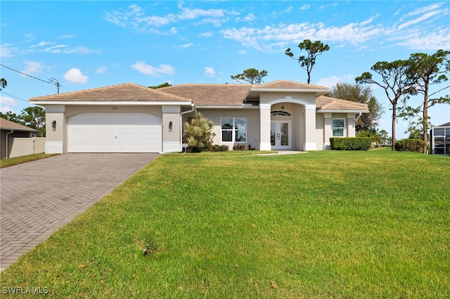 single story home with a front yard, decorative driveway, stucco siding, french doors, and an attached garage