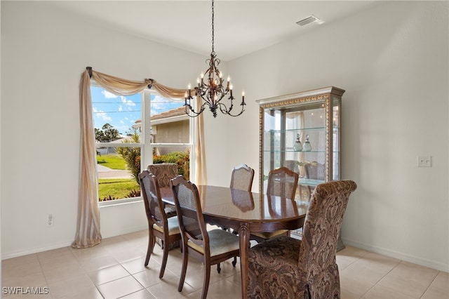 dining space featuring visible vents, baseboards, light tile patterned floors, and a notable chandelier