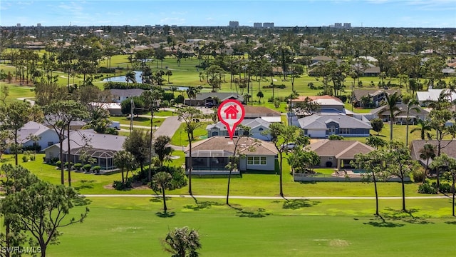 drone / aerial view featuring a water view, view of golf course, and a residential view