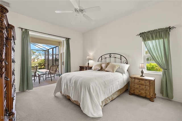 bedroom with light carpet, access to exterior, and ceiling fan