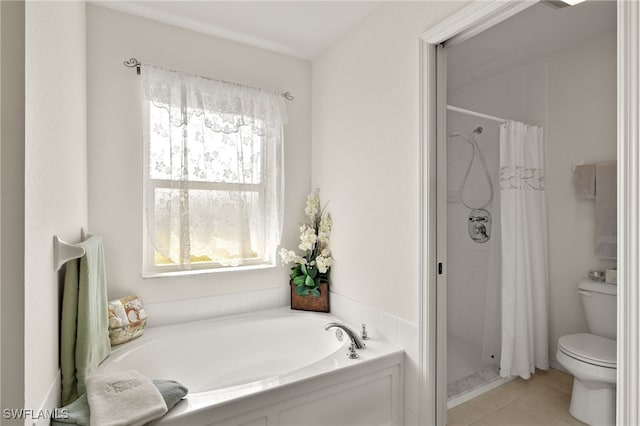bathroom featuring tile patterned flooring, a garden tub, a stall shower, and toilet