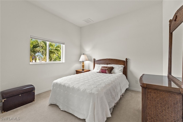 bedroom with carpet floors, baseboards, and visible vents