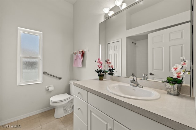 full bathroom featuring tile patterned flooring, vanity, toilet, baseboards, and walk in shower