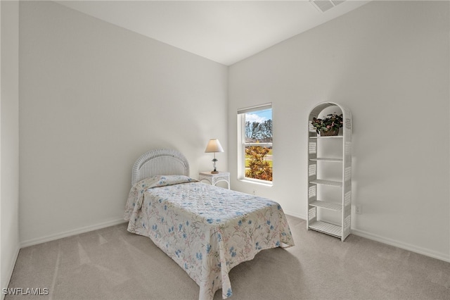 bedroom featuring light carpet