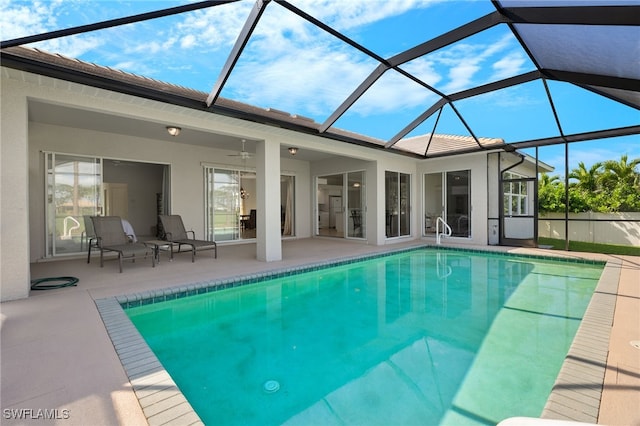 view of swimming pool with a patio area, a lanai, and ceiling fan