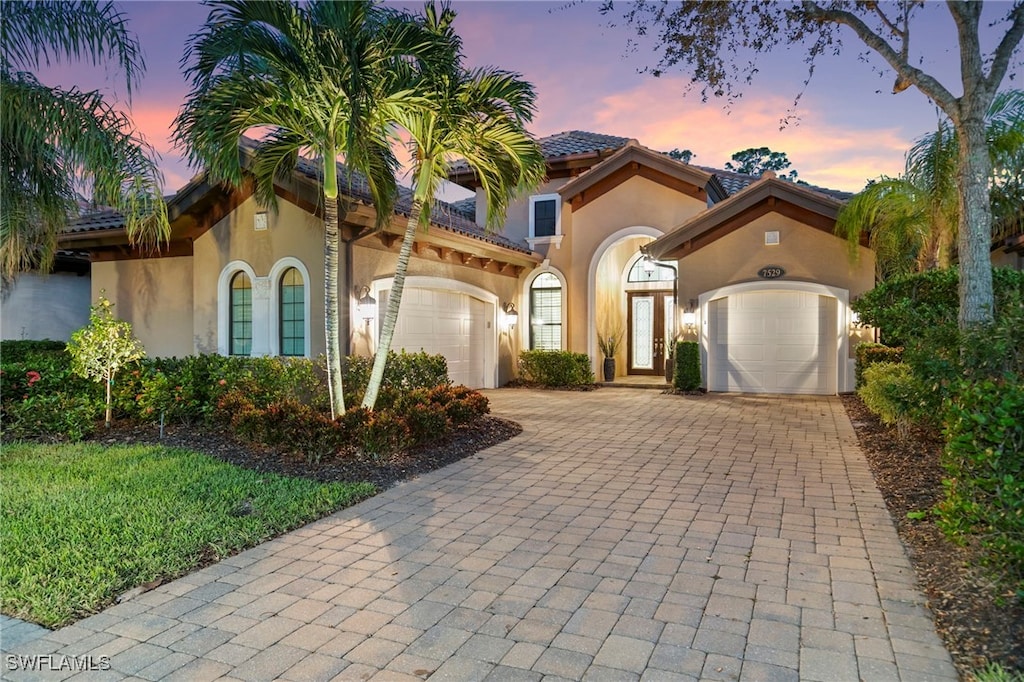 mediterranean / spanish house with a garage