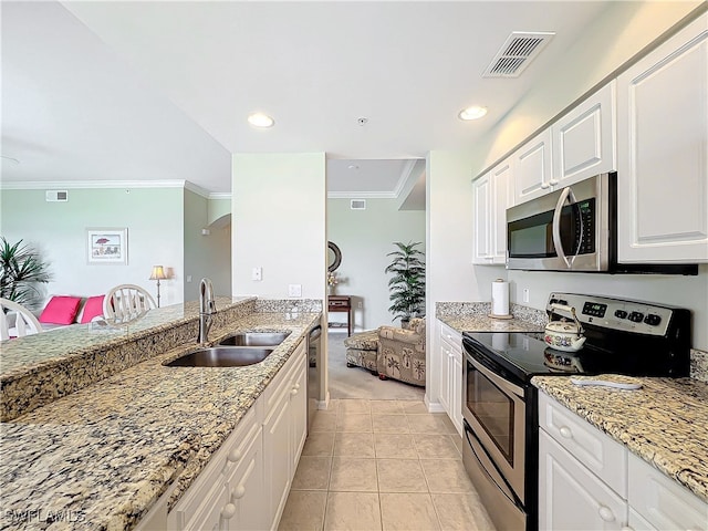 kitchen featuring sink, appliances with stainless steel finishes, light stone countertops, light tile patterned floors, and white cabinets