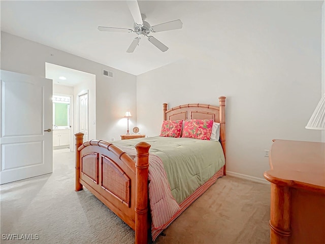 bedroom with ensuite bathroom, ceiling fan, and light carpet