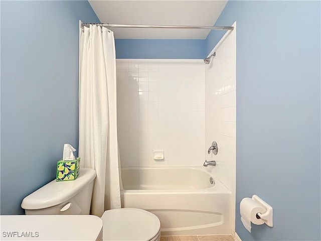 bathroom featuring toilet and shower / bath combo with shower curtain