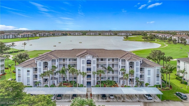 birds eye view of property with a water view and golf course view