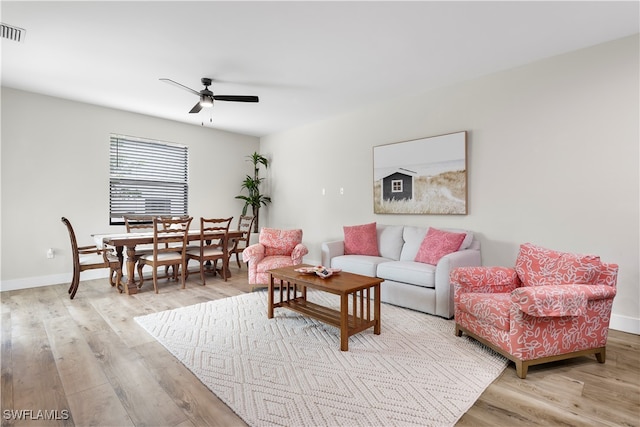 living room featuring ceiling fan and light wood-type flooring