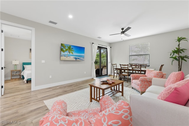 living room featuring light wood-type flooring and ceiling fan