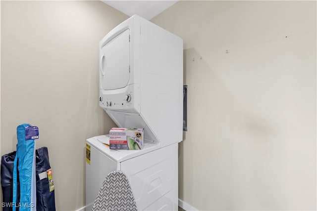 washroom with stacked washing maching and dryer