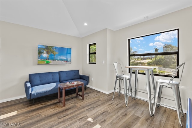 sitting room featuring lofted ceiling and hardwood / wood-style flooring