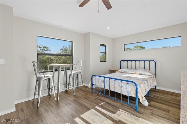 bedroom with hardwood / wood-style floors and ceiling fan