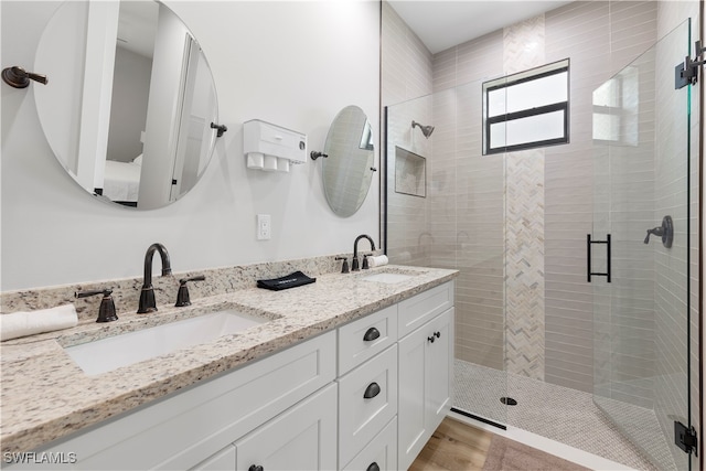 bathroom with vanity, hardwood / wood-style flooring, and an enclosed shower