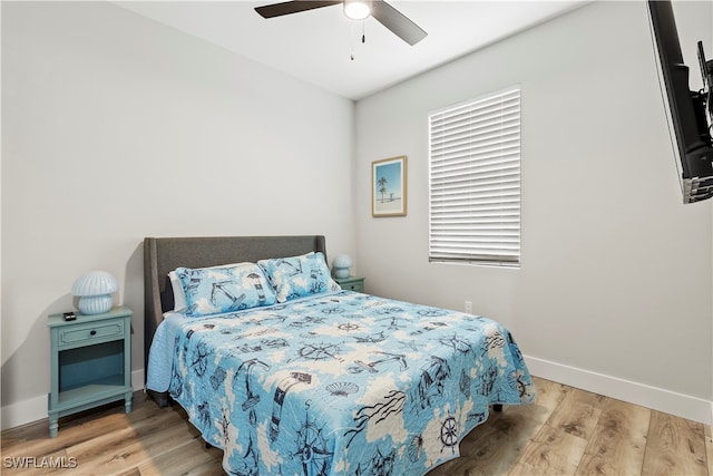 bedroom with light hardwood / wood-style flooring and ceiling fan