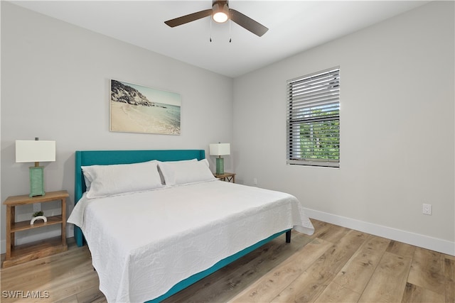 bedroom with light hardwood / wood-style flooring and ceiling fan