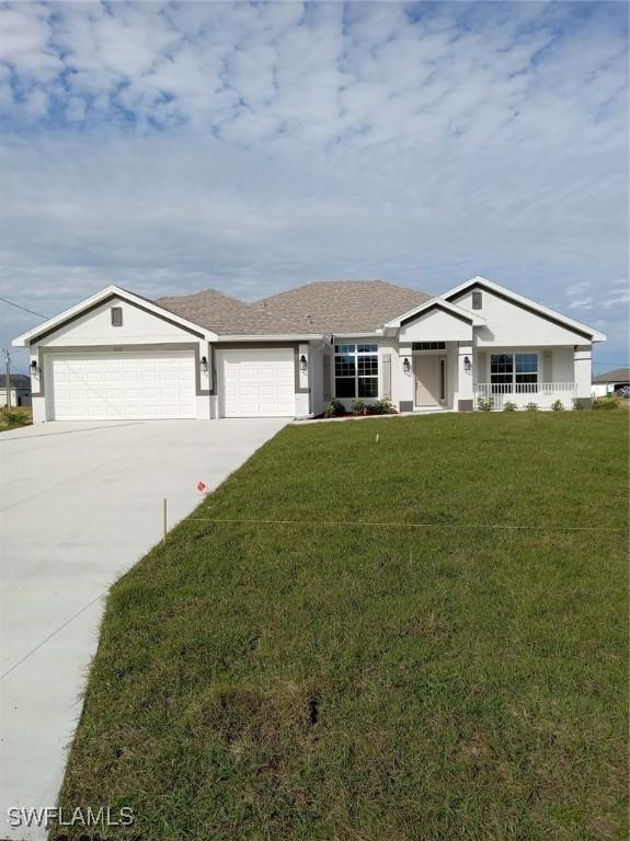 single story home with a front yard and a garage