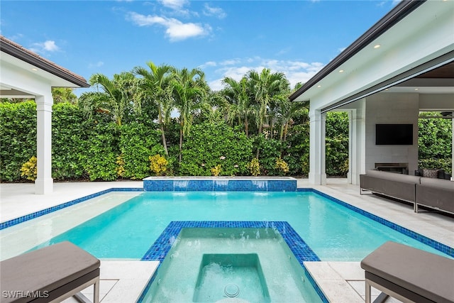 view of pool featuring an in ground hot tub, pool water feature, and a patio area