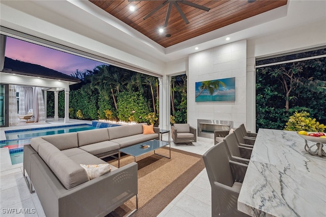 patio terrace at dusk with an outdoor hangout area and ceiling fan