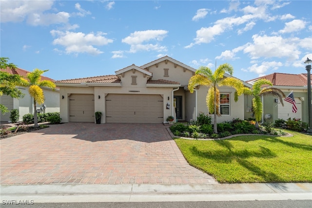 mediterranean / spanish house with a garage and a front yard