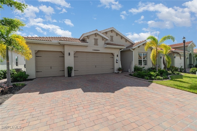 mediterranean / spanish house with a garage