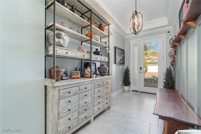 doorway featuring an inviting chandelier, ornamental molding, and light tile patterned flooring